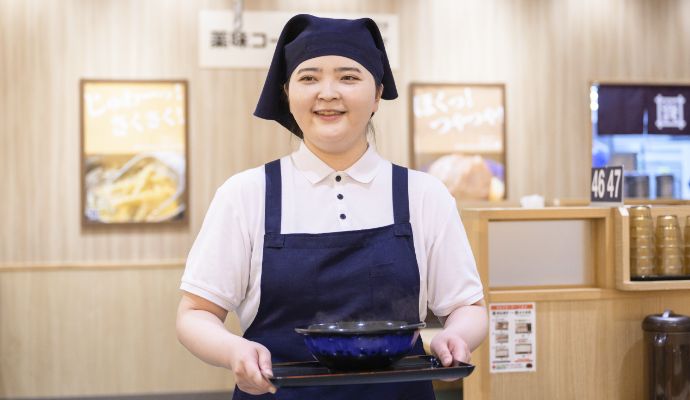 スタッフがうどんを運ぶ様子